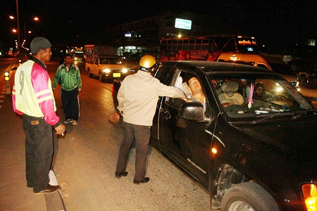 Police try to wake the slumbering driver, to no avail.